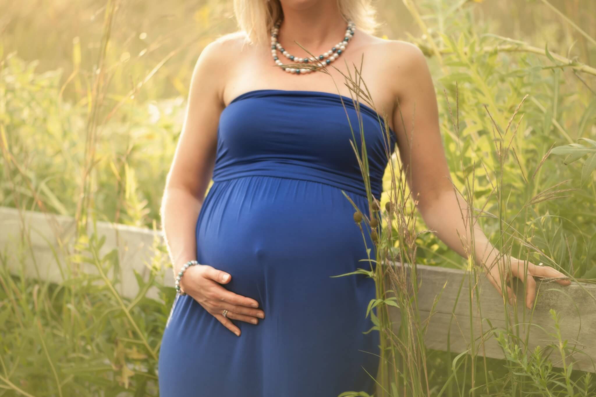 Premium Photo  Close up of pregnant woman wearing pregnancy corset against  backpain at blue surface with copy space